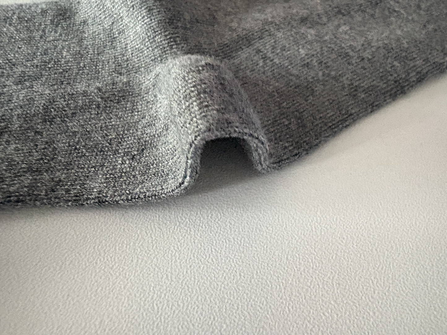 Close-up of gray fabric on a light gray background