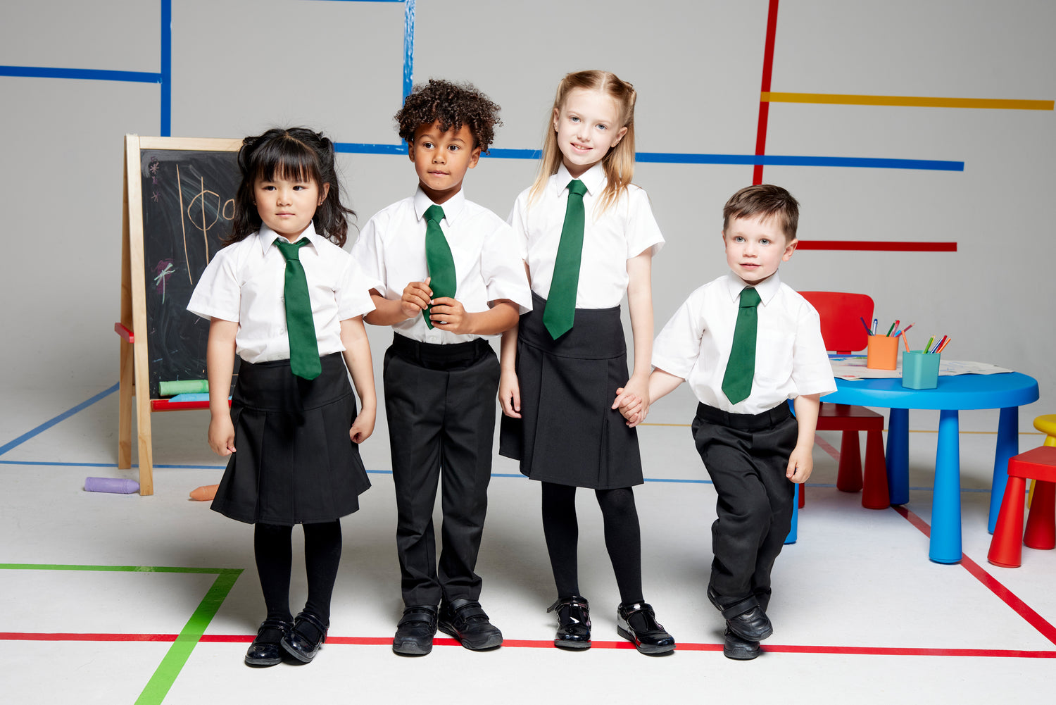 Group of children standing next to each other in School uniform