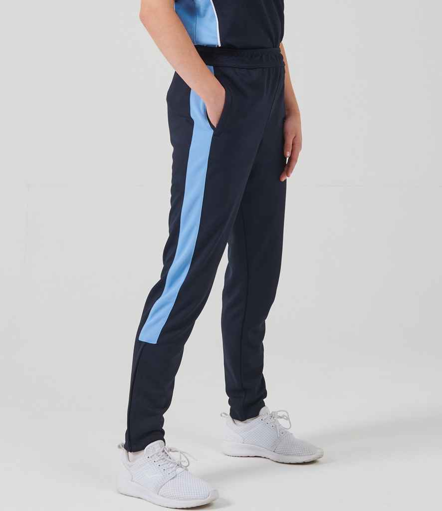 Person wearing navy tracksuit pants with a light blue stripe on a white background