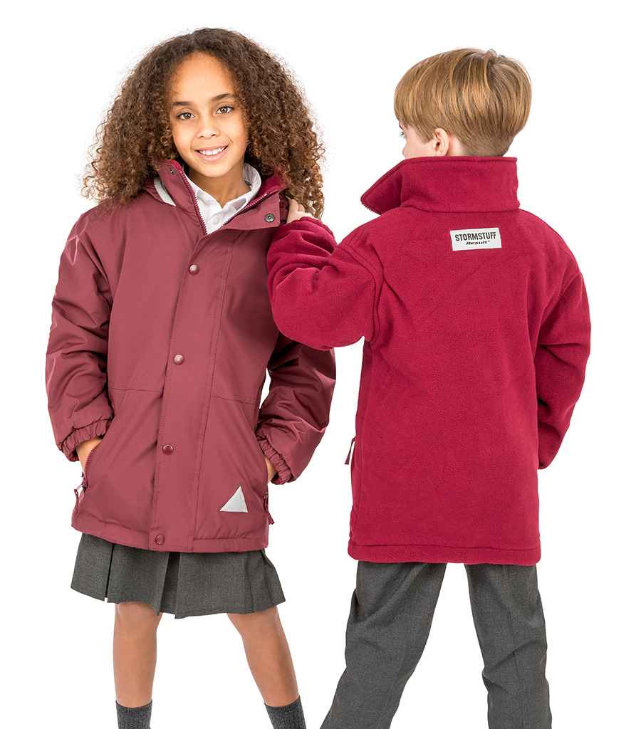 Two children wearing red jackets, one facing forward and the other back, on a white background.