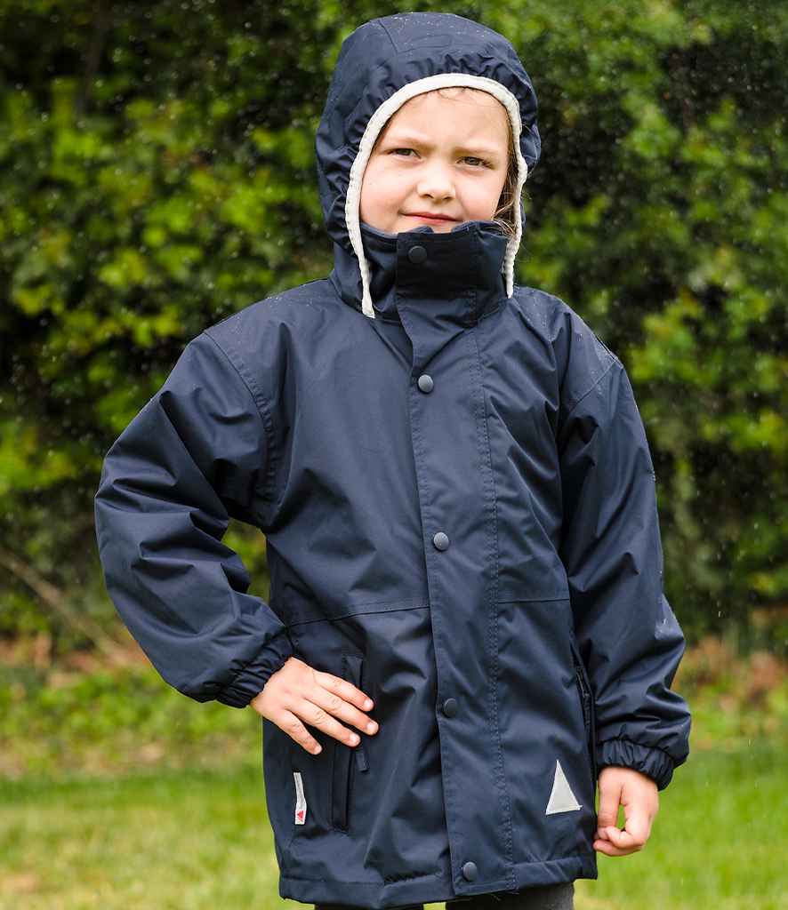 Child wearing a navy raincoat with a hood outdoors