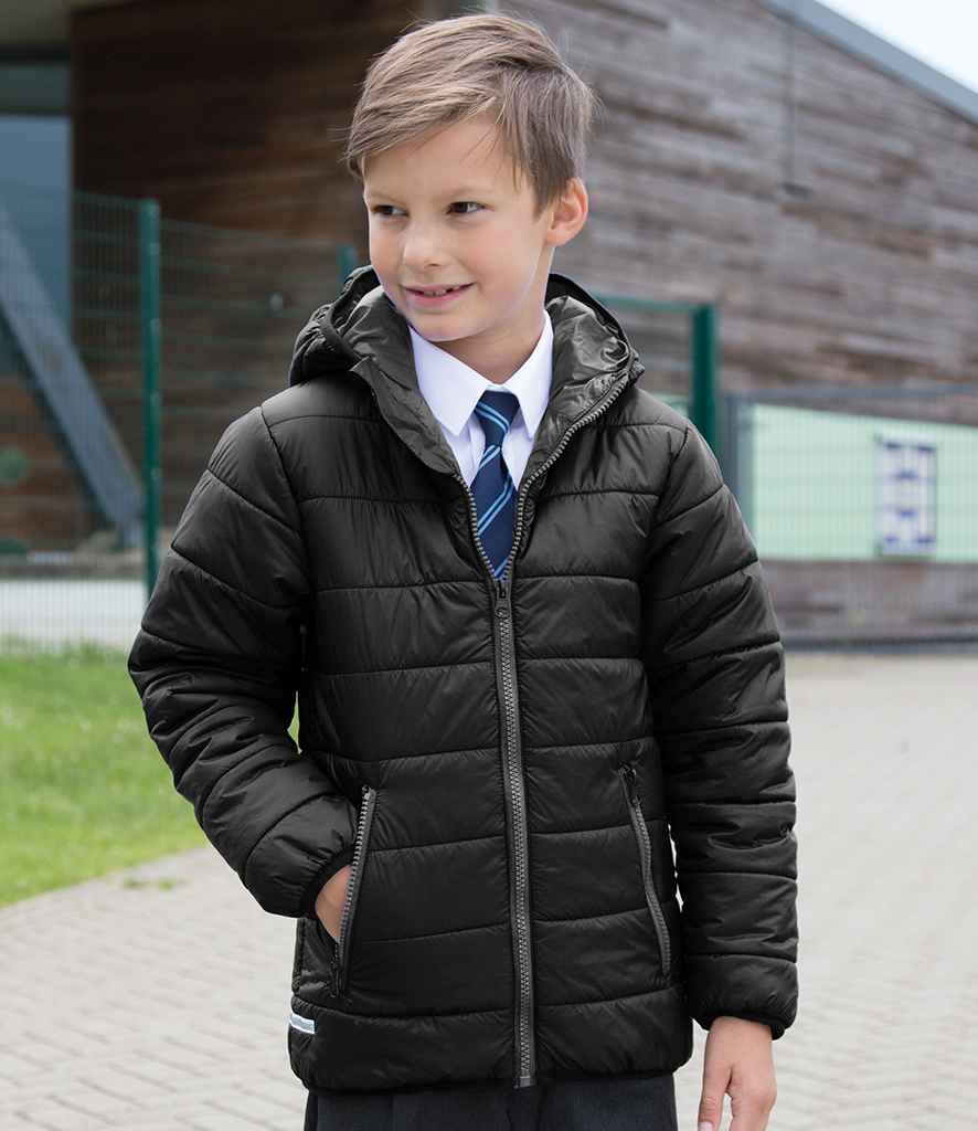 Young boy wearing a black puffer jacket outdoors