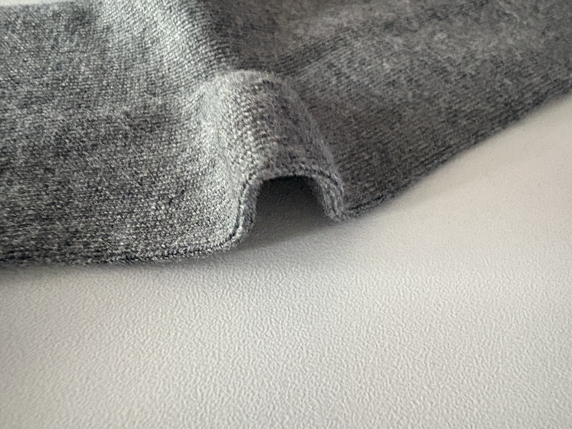 Close-up of gray fabric on a light gray background