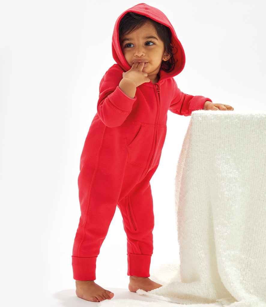 Child wearing a red onesie with a hood on a white background