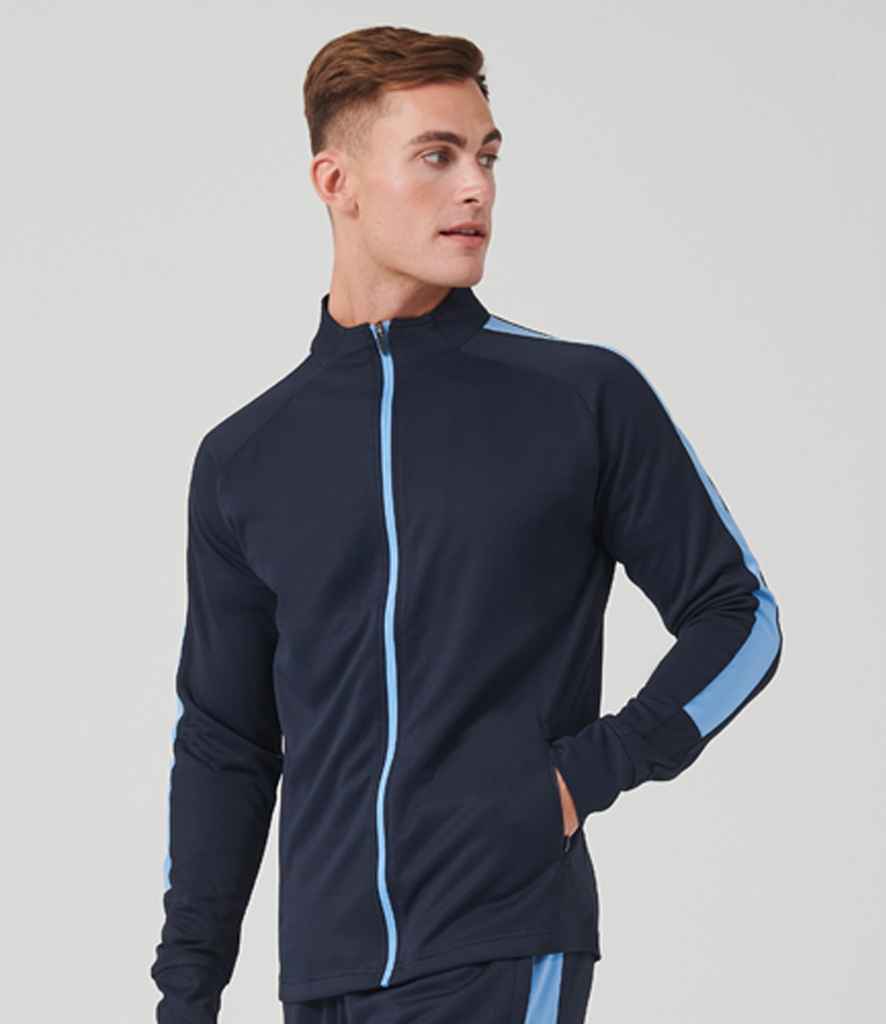 Man wearing a navy tracksuit with blue accents on a light gray background